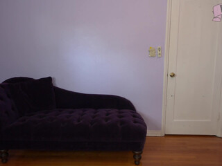 Echo Noir black-haired handjob lying on the couch