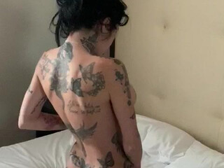 Megan Inky aka inky real busty  cam girl  caresses her lips.
