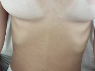 Lia Adorable female fingers her anus